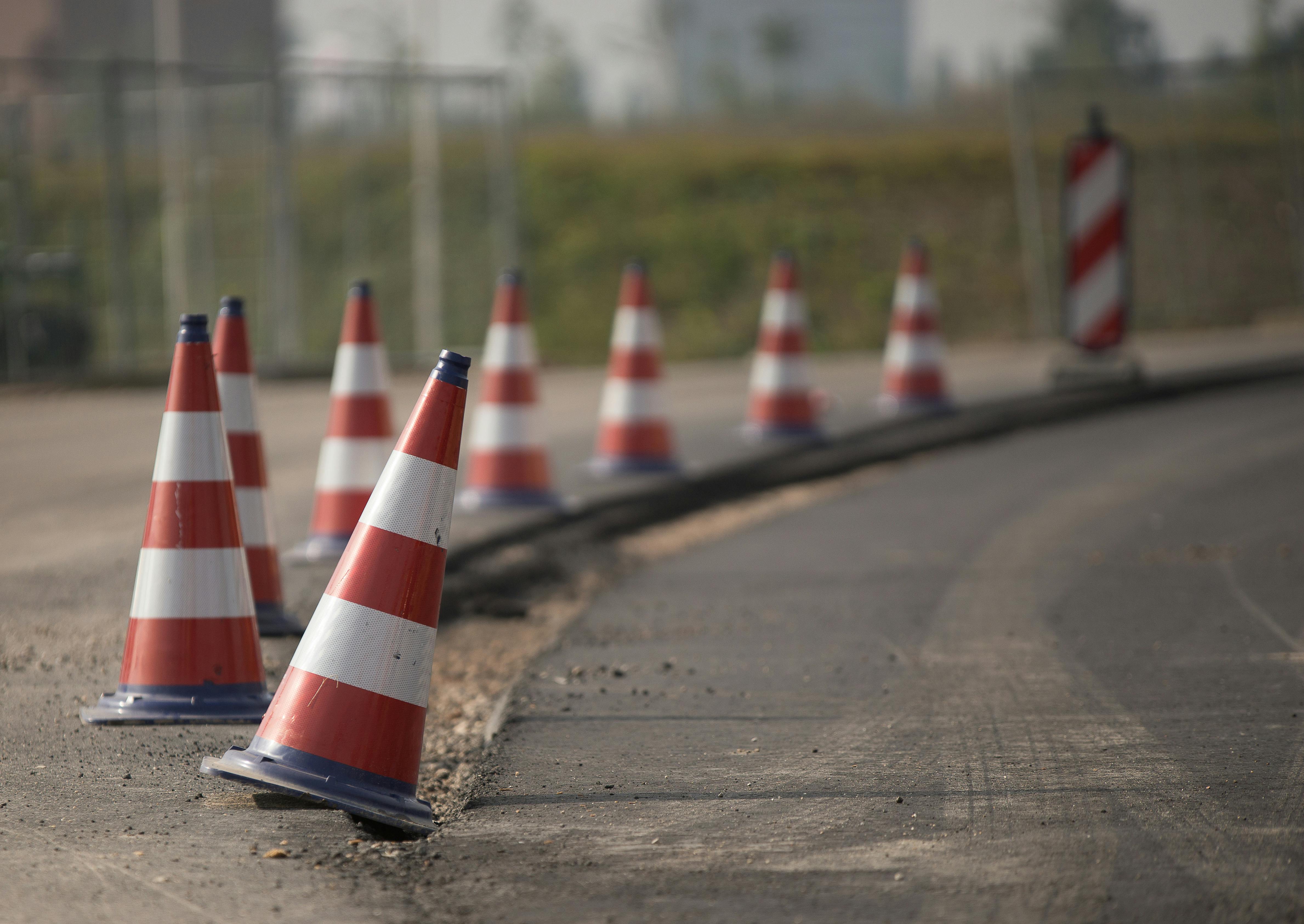 Traffic cones on road edge depicting roadblocks in FNOL process flow