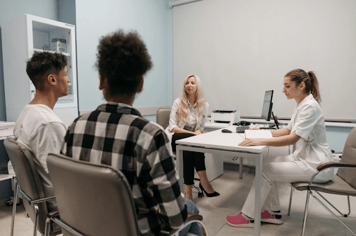 People in a medical appointment discussing legal and regulatory compliance in healthcare