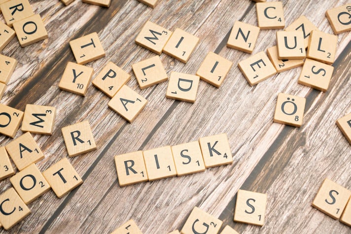  letter blocks forming the word ‘risk’ denoting risk management avoidance strategies.