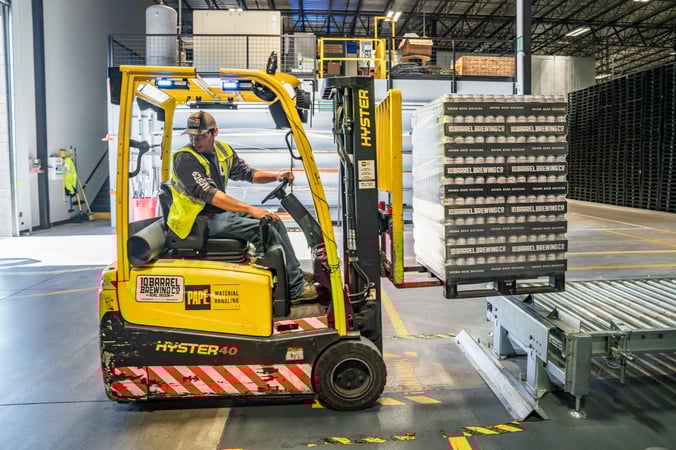 a man using a forklift, part of the logistics industry requiring risk management