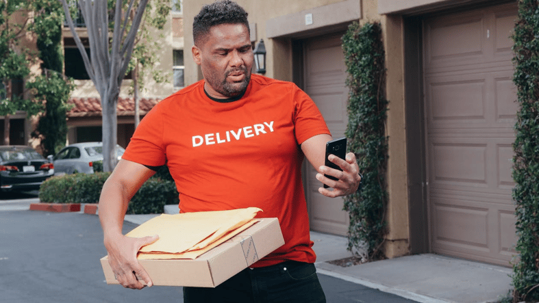 Confused delivery worker facing supply chain incident management issue on phone