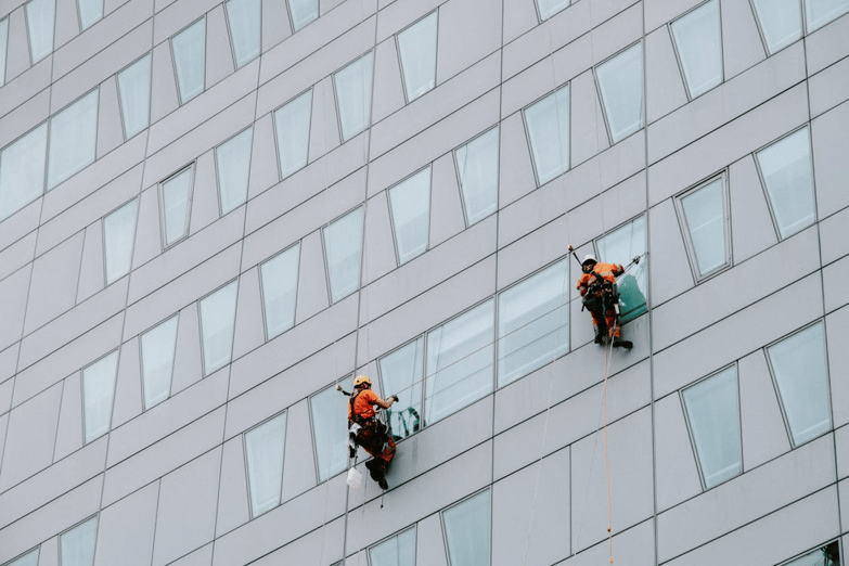 Workers in a high-risk job highlighting the need for claim management solutions and workplace safety compliance.